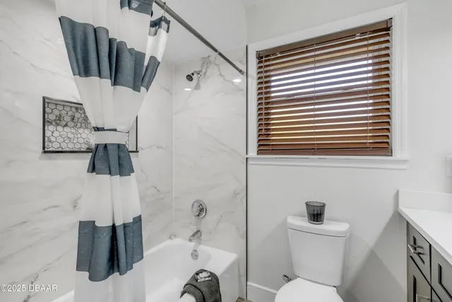 a view of a house with a backyard and a patio