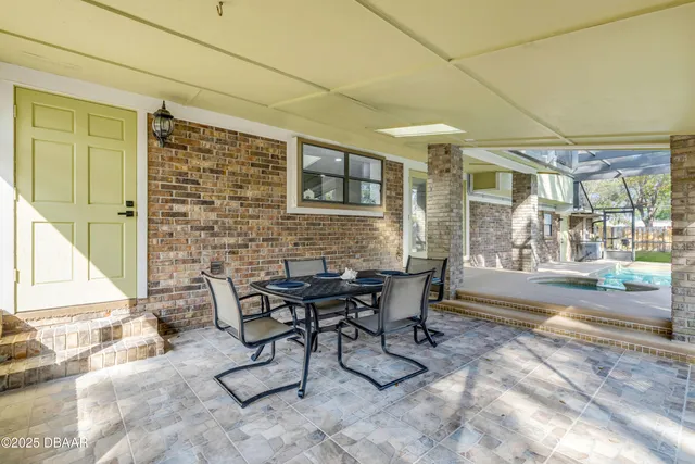 a backyard of a house with table and chairs
