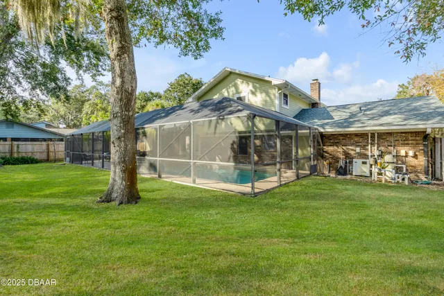 a view of a yard with plants and trees