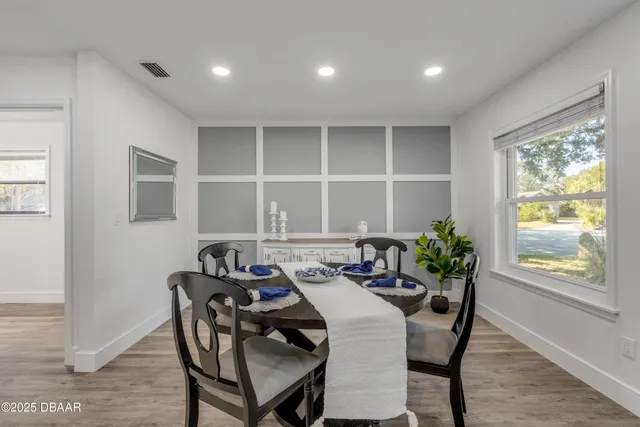 a view of a dining room with furniture and a potted plant