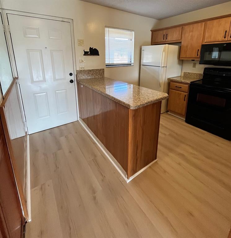 9449 Boca Cove Circle, Unit 914 Boca Raton, FL 33428 - Photo 5 of 17 Brand new flooring in kitchen/entryway