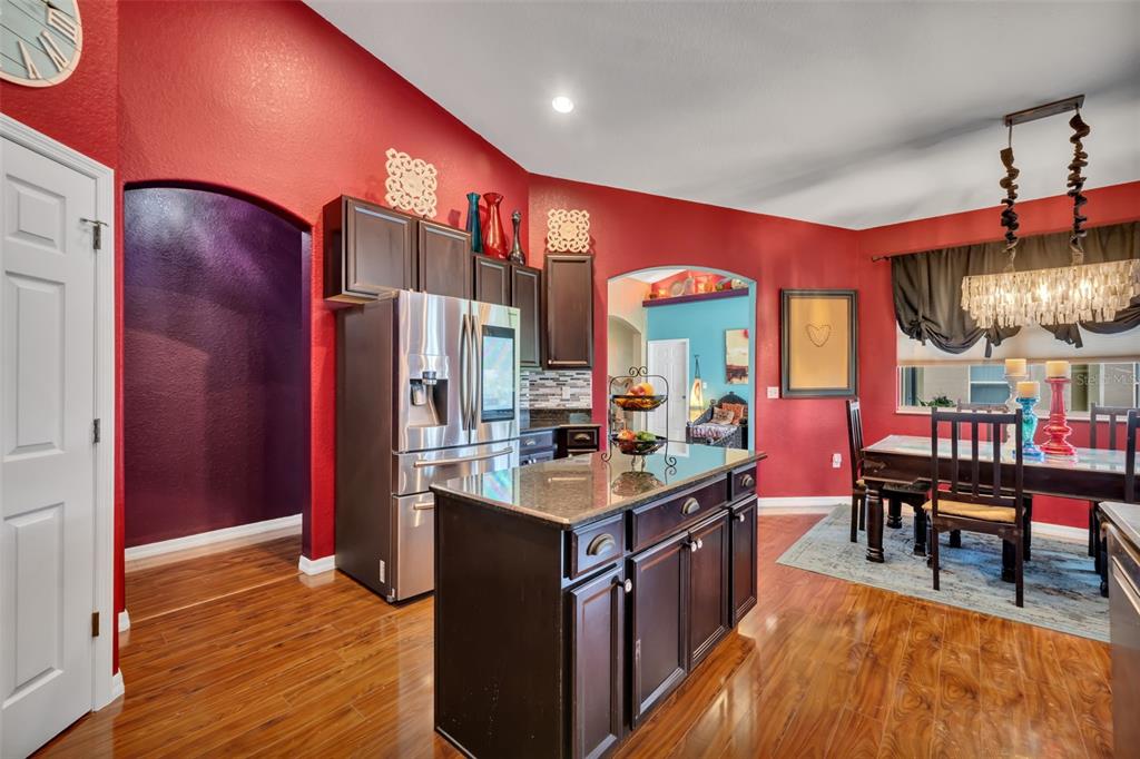 4946 Northeast 124th Road Oxford, FL 34484 - Photo 20 of 69 a kitchen with stainless steel appliances granite countertop a stove and a dining table