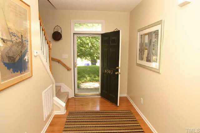 6507 Draebury Lane Durham, NC 27713 - Photo 2 of 9 a view of a hallway with wooden floor and a rug