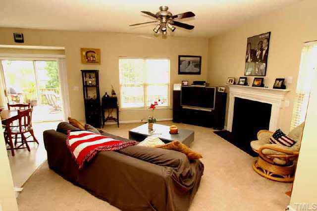 6507 Draebury Lane Durham, NC 27713 - Photo 3 of 9 a bedroom with a bed and wooden floor