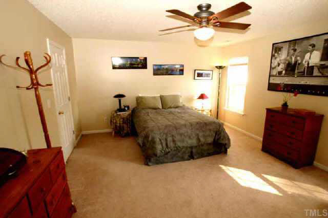 6507 Draebury Lane Durham, NC 27713 - Photo 6 of 9 a bedroom with a bed and a dresser