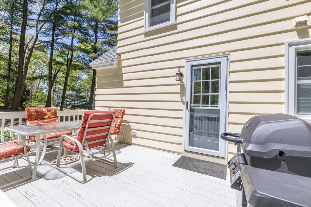 16 Bashaw Road Sutton, MA 01590 - Photo 32 of 37 a view of a patio with a table and chairs and a barbeque