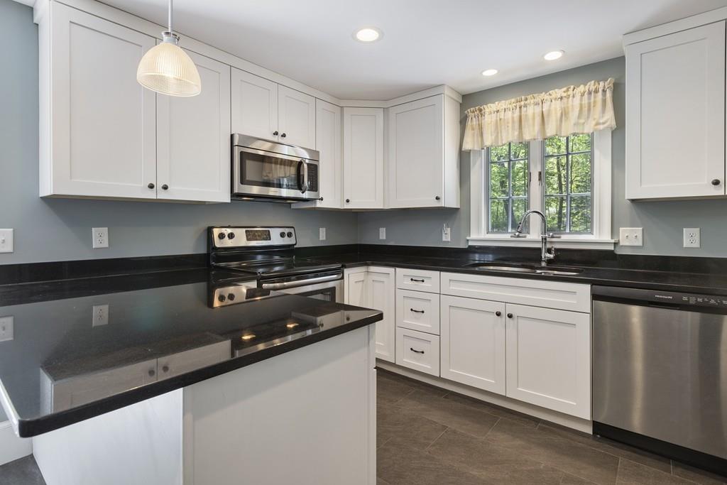 16 Bashaw Road Sutton, MA 01590 - Photo 5 of 37 a kitchen with stainless steel appliances granite countertop a sink a stove and a microwave