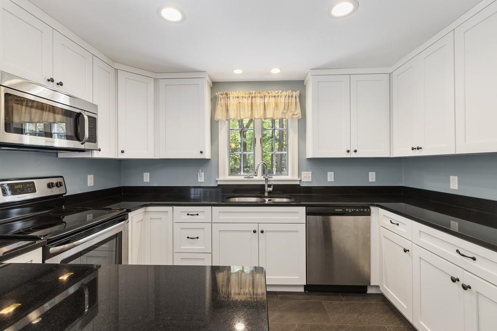 16 Bashaw Road Sutton, MA 01590 - Photo 7 of 37 a kitchen with granite countertop white cabinets and black appliances