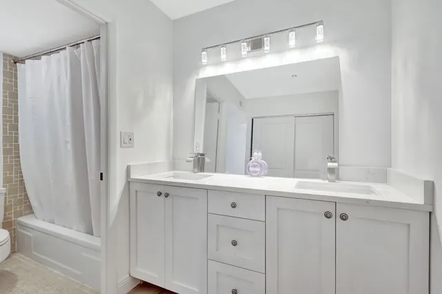 a bathroom with a double vanity sink and mirror