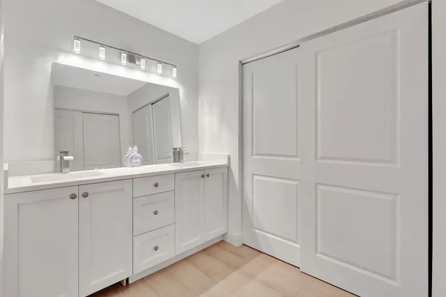 a spacious bathroom with a double vanity sink and a mirror