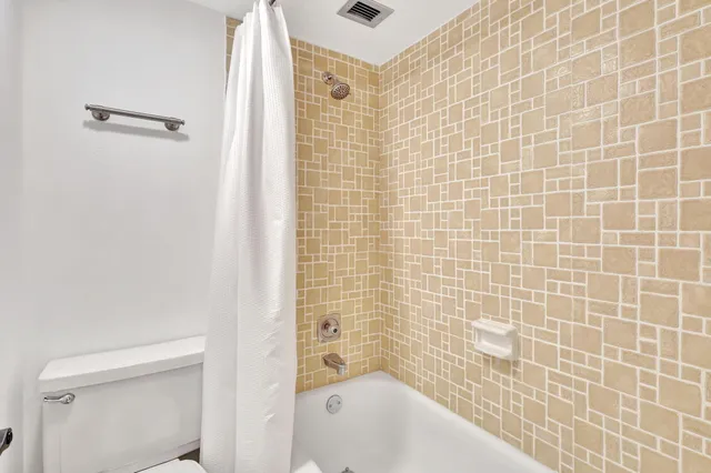a bathroom with a bathtub and shower