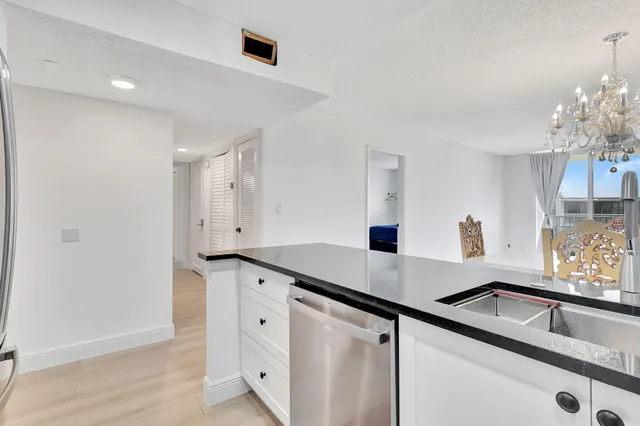 a kitchen with granite countertop a sink and cabinets