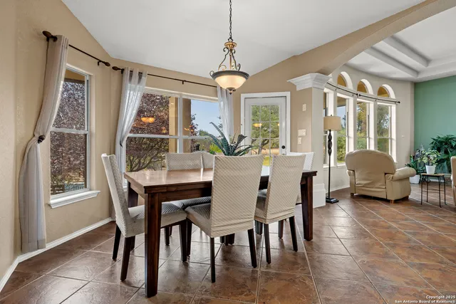 a view of a dining room with furniture window and outside view