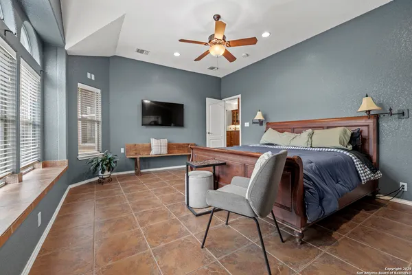 a bedroom with a bed and glass windows