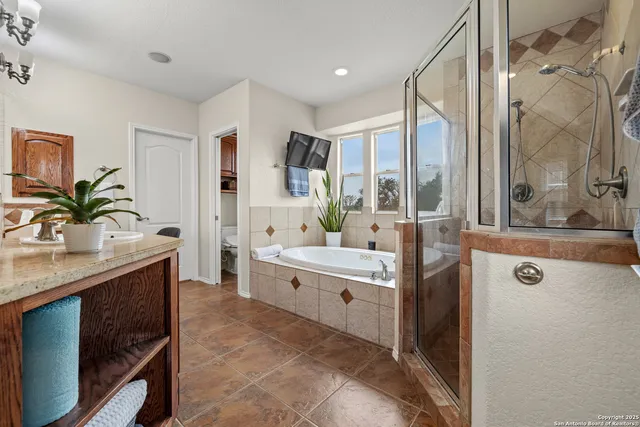 a spacious bathroom with a shower sink vanity and mirror