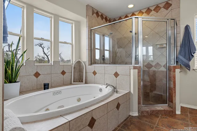 a bathroom with a bathtub and a shower