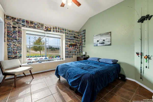 a bed sitting in a bedroom next to a window