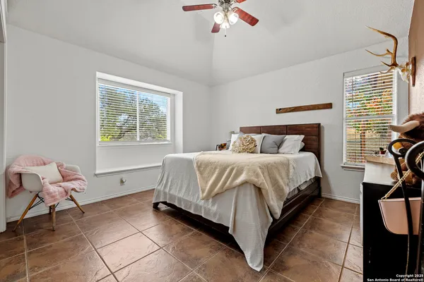 a spacious bedroom with a bed and a chandelier
