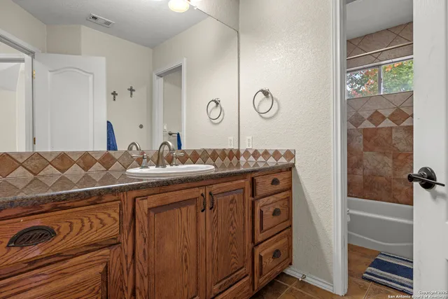 a bathroom with a sink a vanity and a mirror