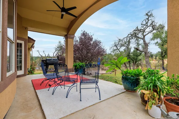 a view of a porch with furniture and a yard