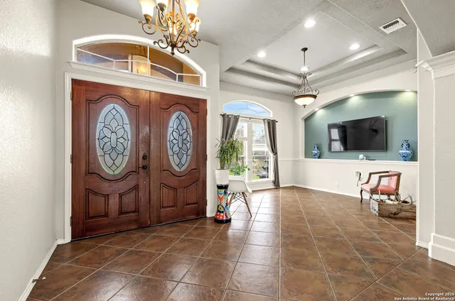 a living room with furniture a flat screen tv and a wall clock