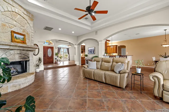 a living room with furniture a fireplace and a flat screen tv