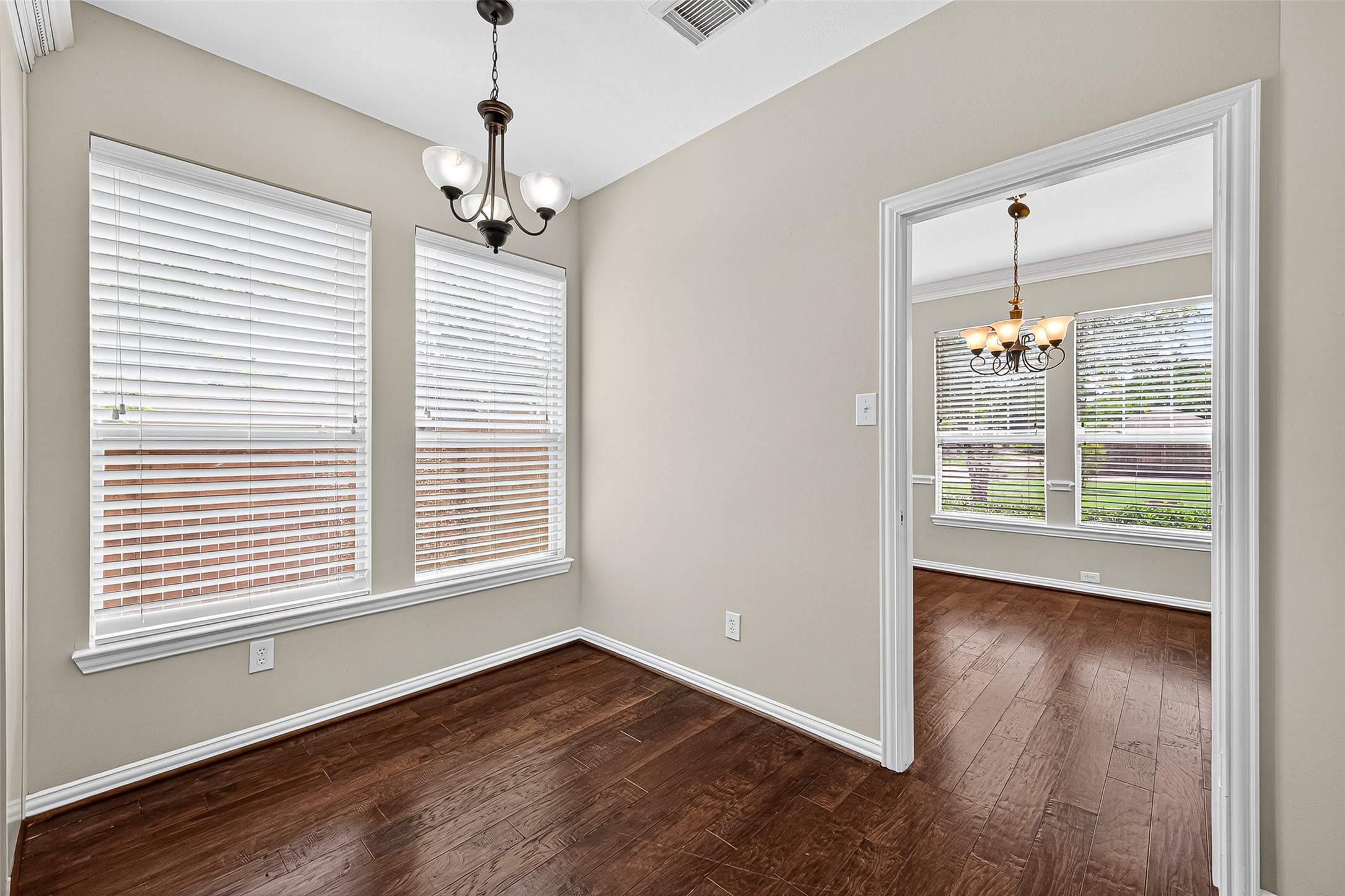 30 Whetstone Ridge Way The Woodlands, TX 77382 - Photo 11 of 39 a view of an empty room with wooden floor and a window