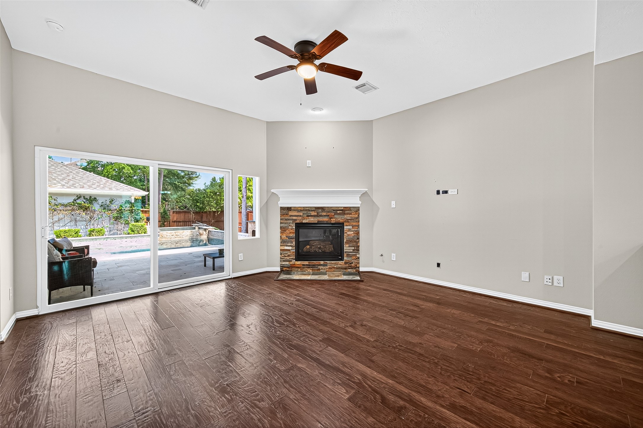 30 Whetstone Ridge Way The Woodlands, TX 77382 - Photo 12 of 39 an empty room with wooden floor and a fireplace