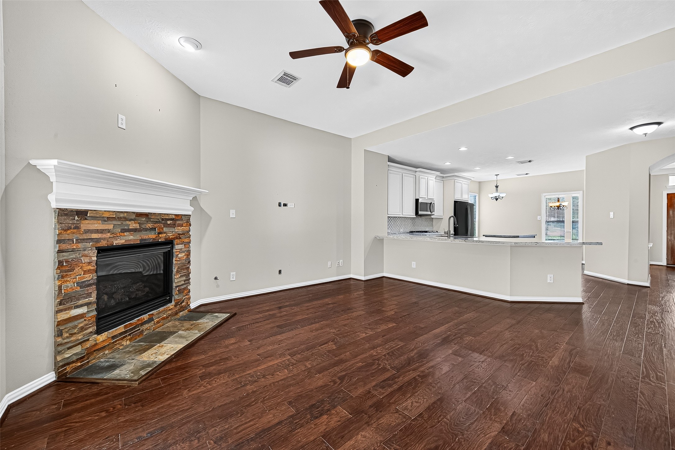 30 Whetstone Ridge Way The Woodlands, TX 77382 - Photo 13 of 39 a view of a kitchen an empty room and wooden floor