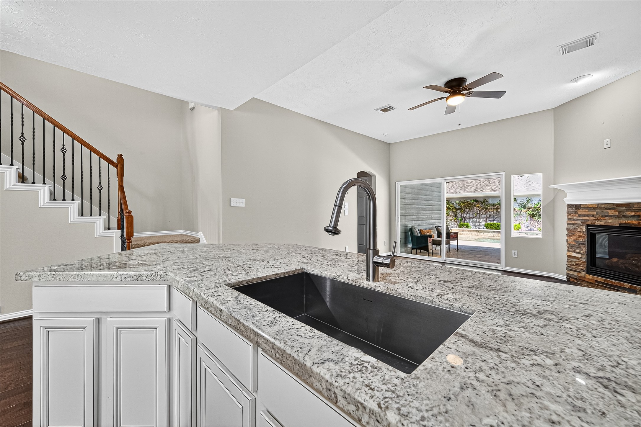 30 Whetstone Ridge Way The Woodlands, TX 77382 - Photo 19 of 39 a kitchen with granite countertop a sink a counter top space and cabinets