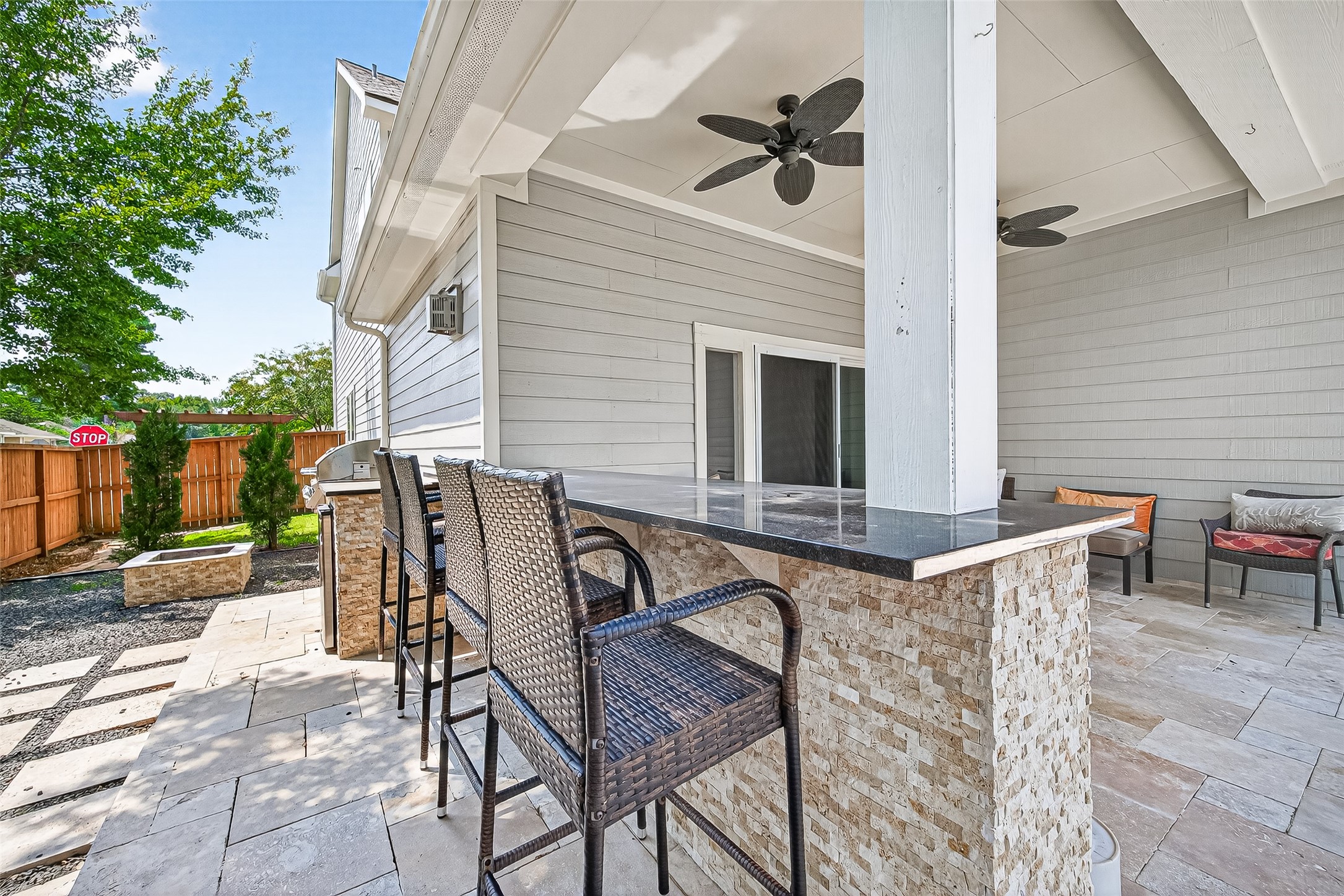 30 Whetstone Ridge Way The Woodlands, TX 77382 - Photo 34 of 39 a view of a patio with table and chairs with wooden fence