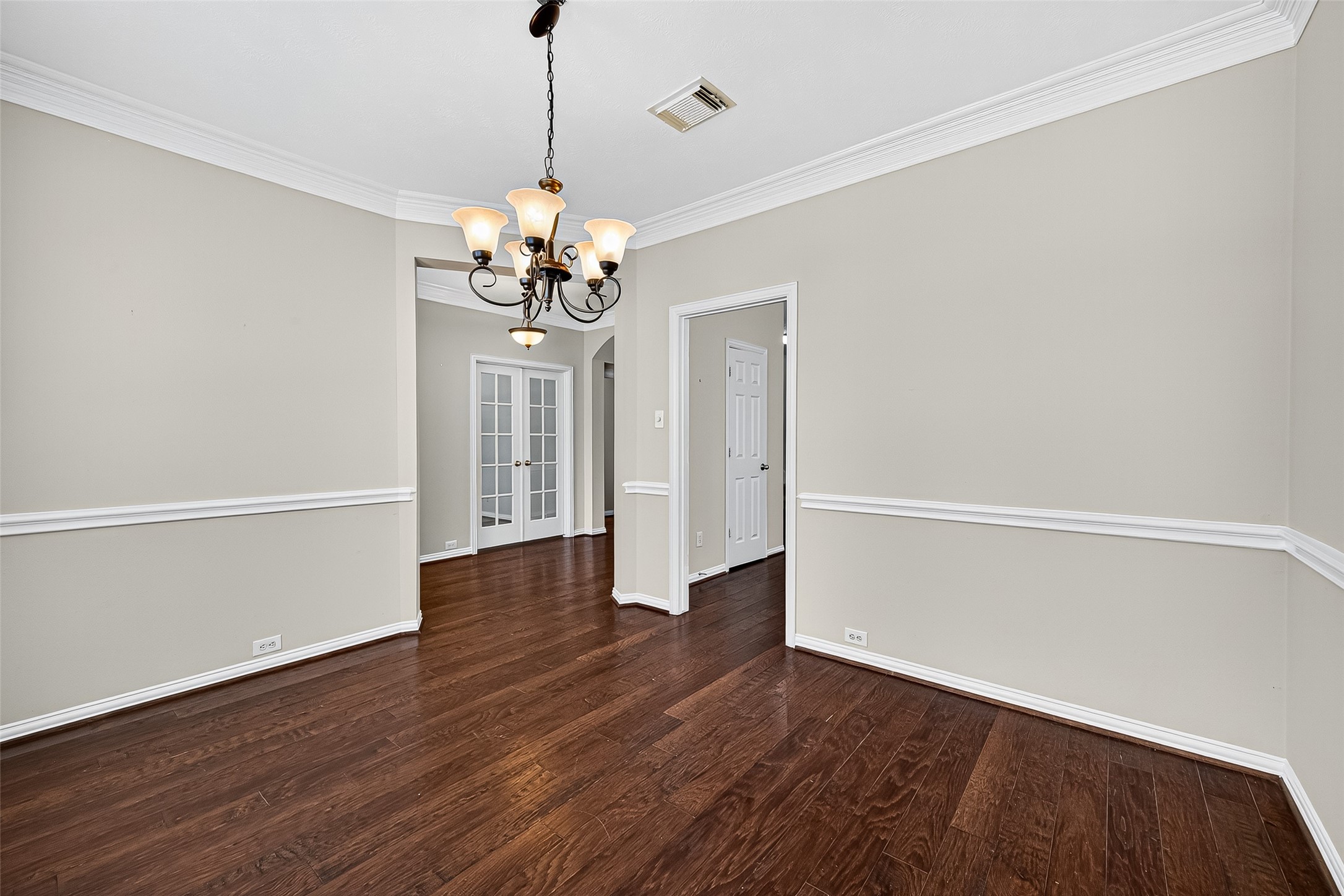 30 Whetstone Ridge Way The Woodlands, TX 77382 - Photo 7 of 39 a view of a room with wooden floor and chandelier