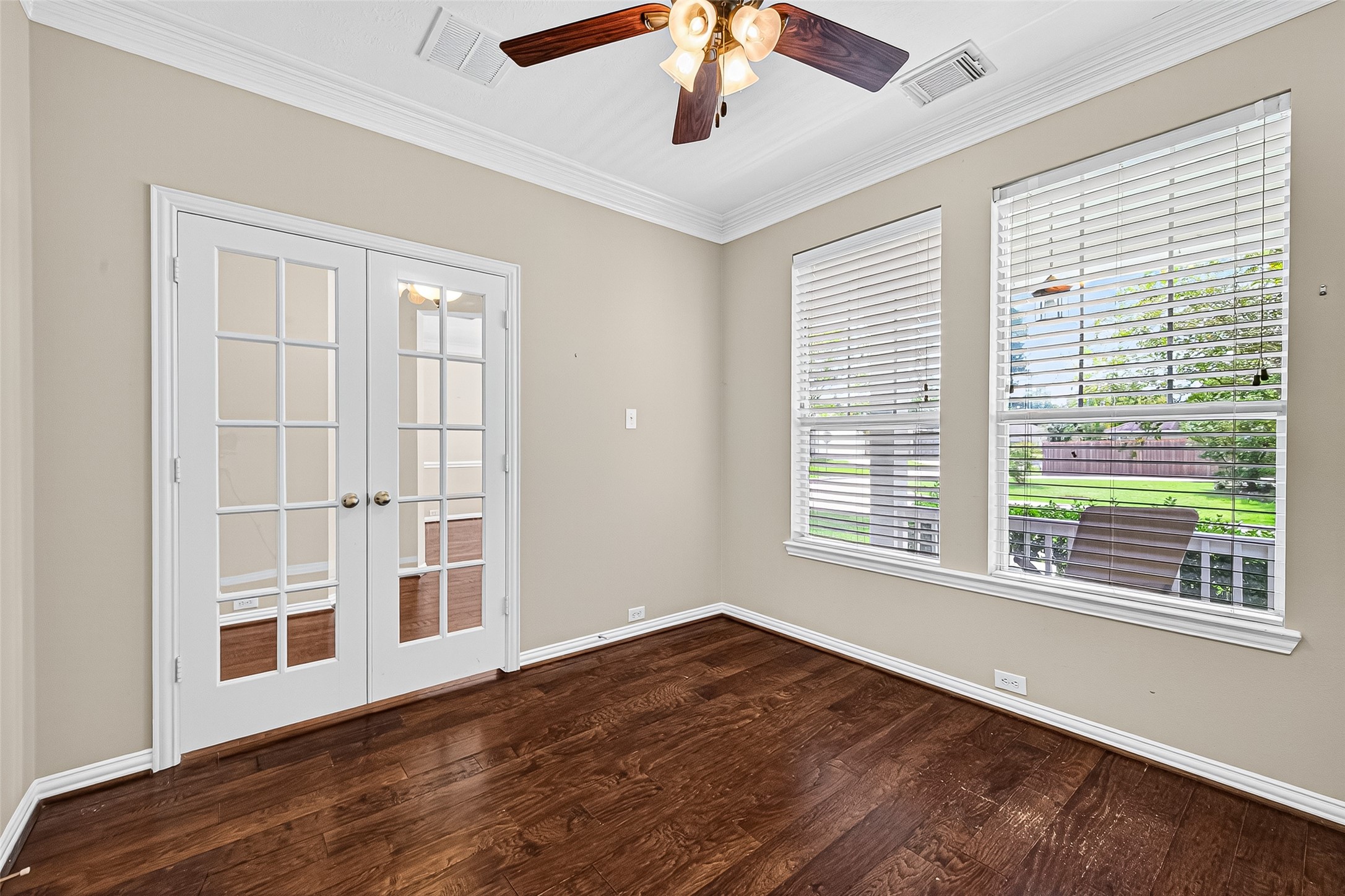 30 Whetstone Ridge Way The Woodlands, TX 77382 - Photo 9 of 39 a view of an empty room with wooden floor and a window