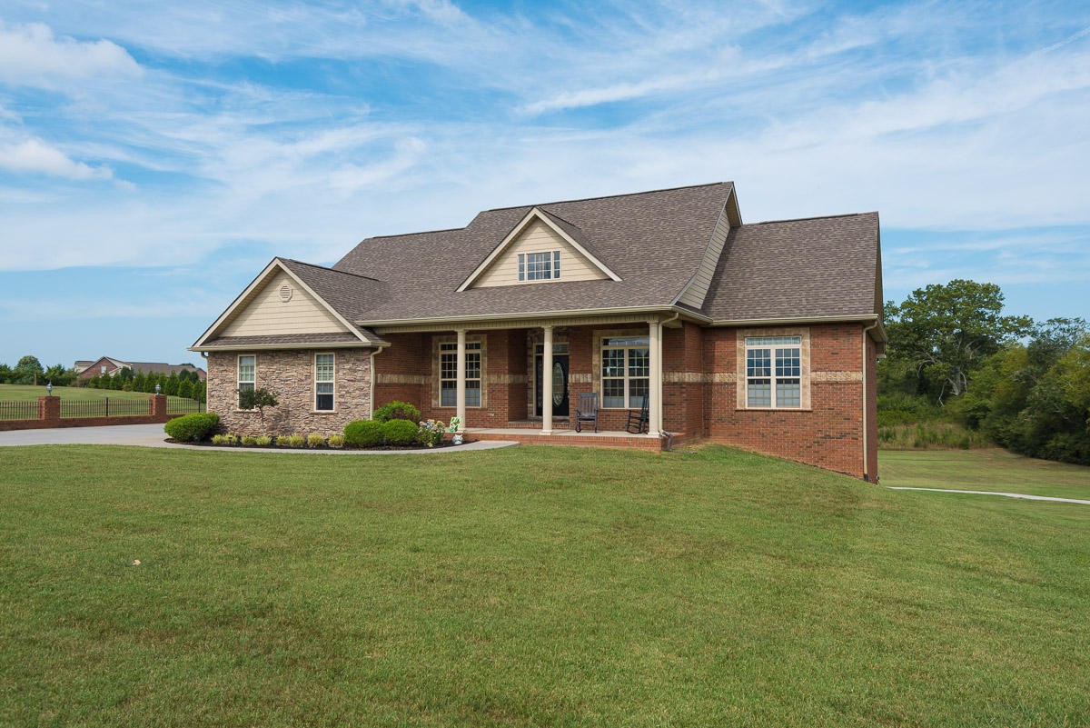 a front view of a house with a garden and yard