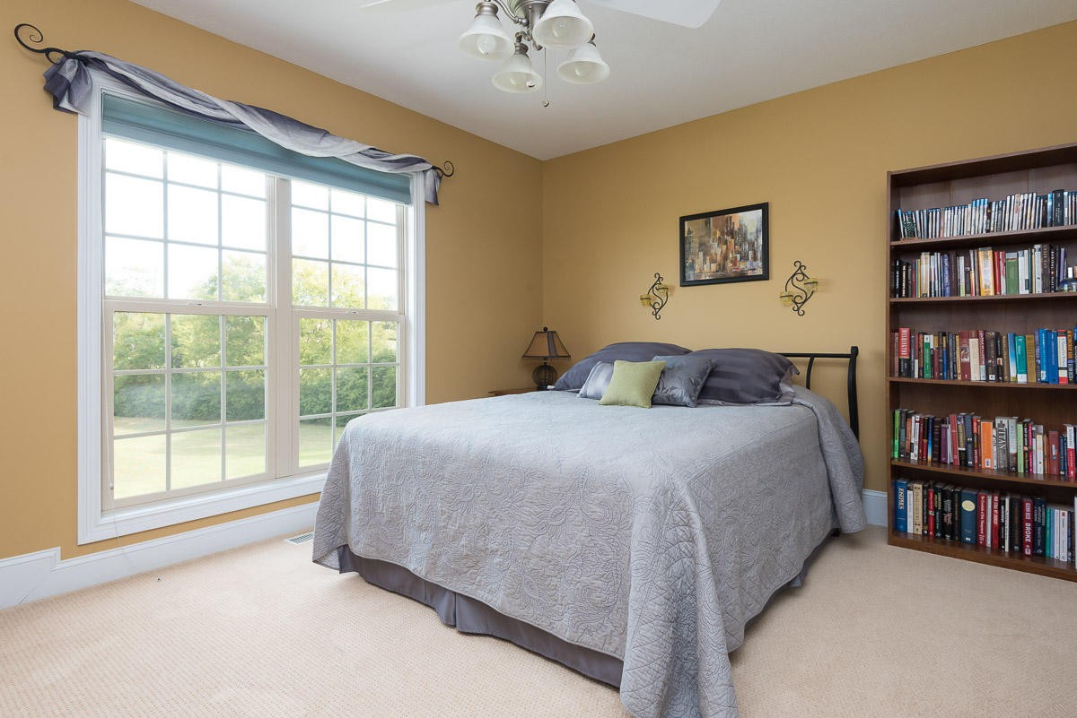 3929 Old Niles Ferry Road Maryville, TN 37801 - Photo 14 of 26 a bedroom with a large bed and a book shelf