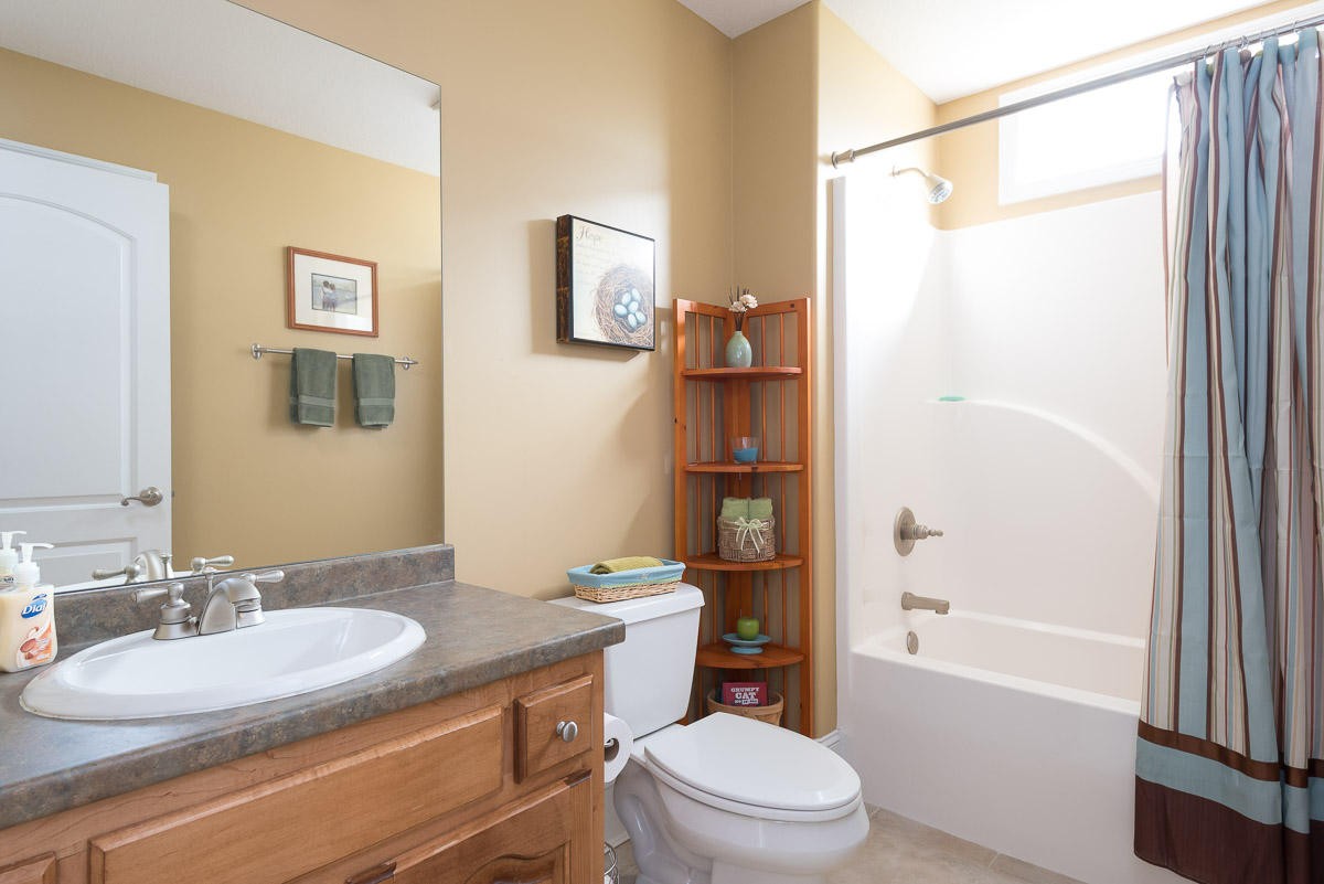 3929 Old Niles Ferry Road Maryville, TN 37801 - Photo 15 of 26 a bathroom with a granite countertop sink toilet a mirror a vanity and shower
