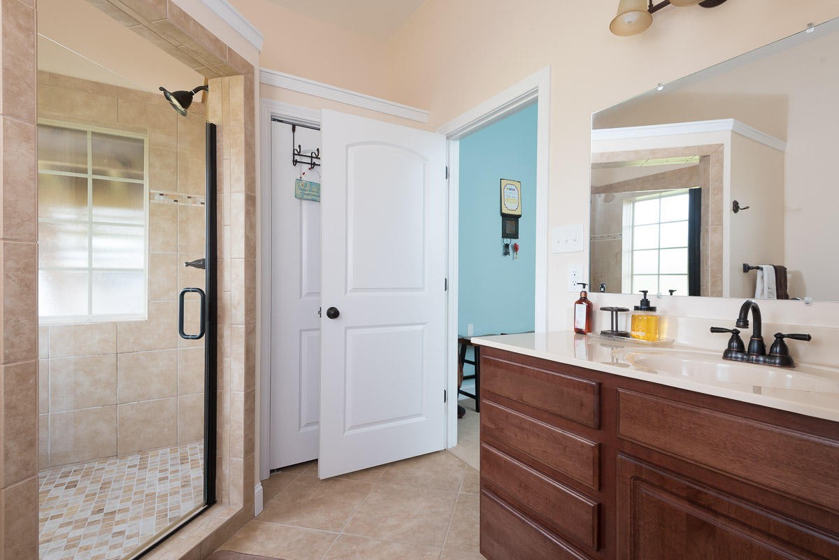 3929 Old Niles Ferry Road Maryville, TN 37801 - Photo 20 of 26 a bathroom with a shower sink and mirror