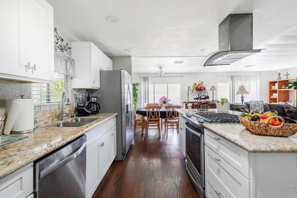 1925 Otay Lakes Road, Unit 157 Chula Vista, CA 91913 - Photo 1 of 1 a kitchen with granite countertop lots of counter top space and dining table