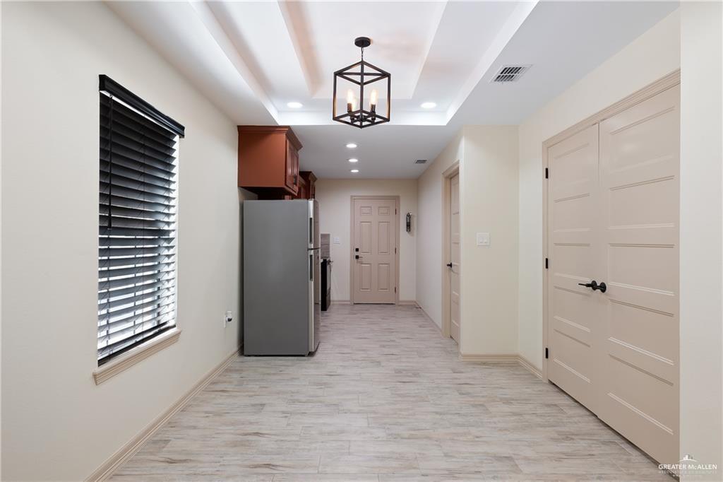 2118 Earth Lane Mission, TX 78573 - Photo 12 of 26 wooden floor in an empty room with a window