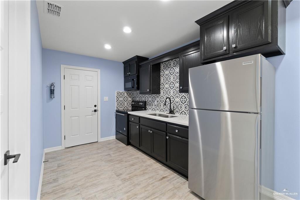 2118 Earth Lane Mission, TX 78573 - Photo 15 of 26 a kitchen with stainless steel appliances granite countertop a refrigerator and a sink