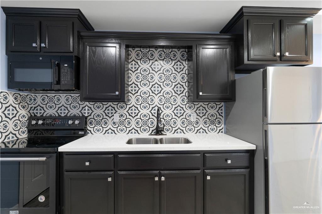 2118 Earth Lane Mission, TX 78573 - Photo 3 of 26 a sink a refrigerator and cabinets