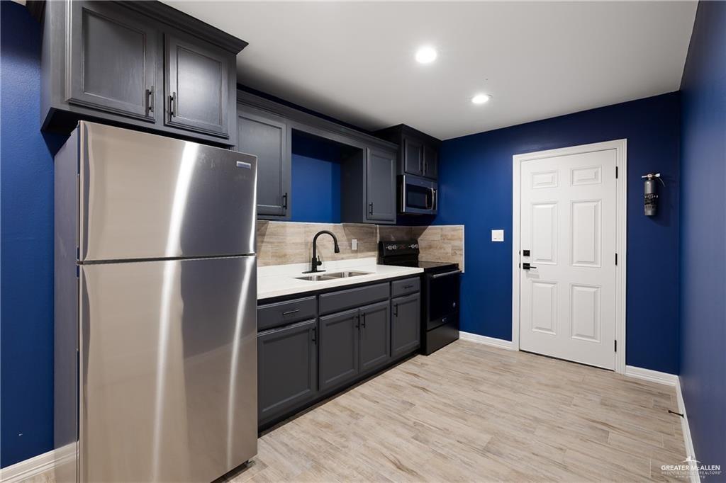 2118 Earth Lane Mission, TX 78573 - Photo 7 of 26 a kitchen with stainless steel appliances granite countertop a refrigerator and a sink
