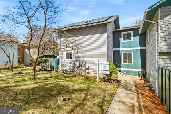 a backyard of a house with table and chairs