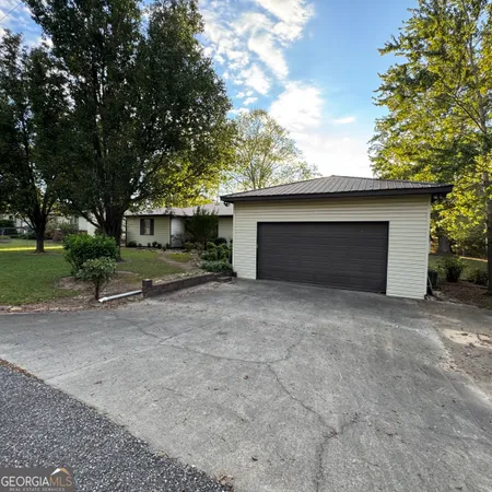 a view of a house with a yard and garage