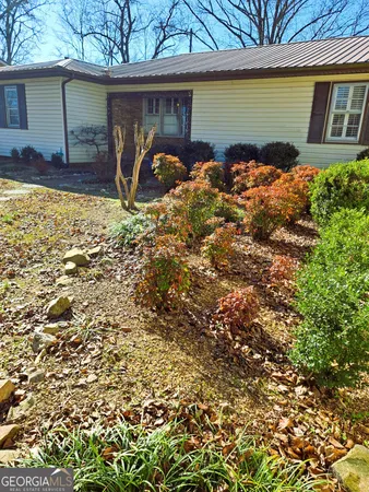 a front view of a house with a garden