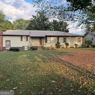 a view of backyard with large trees