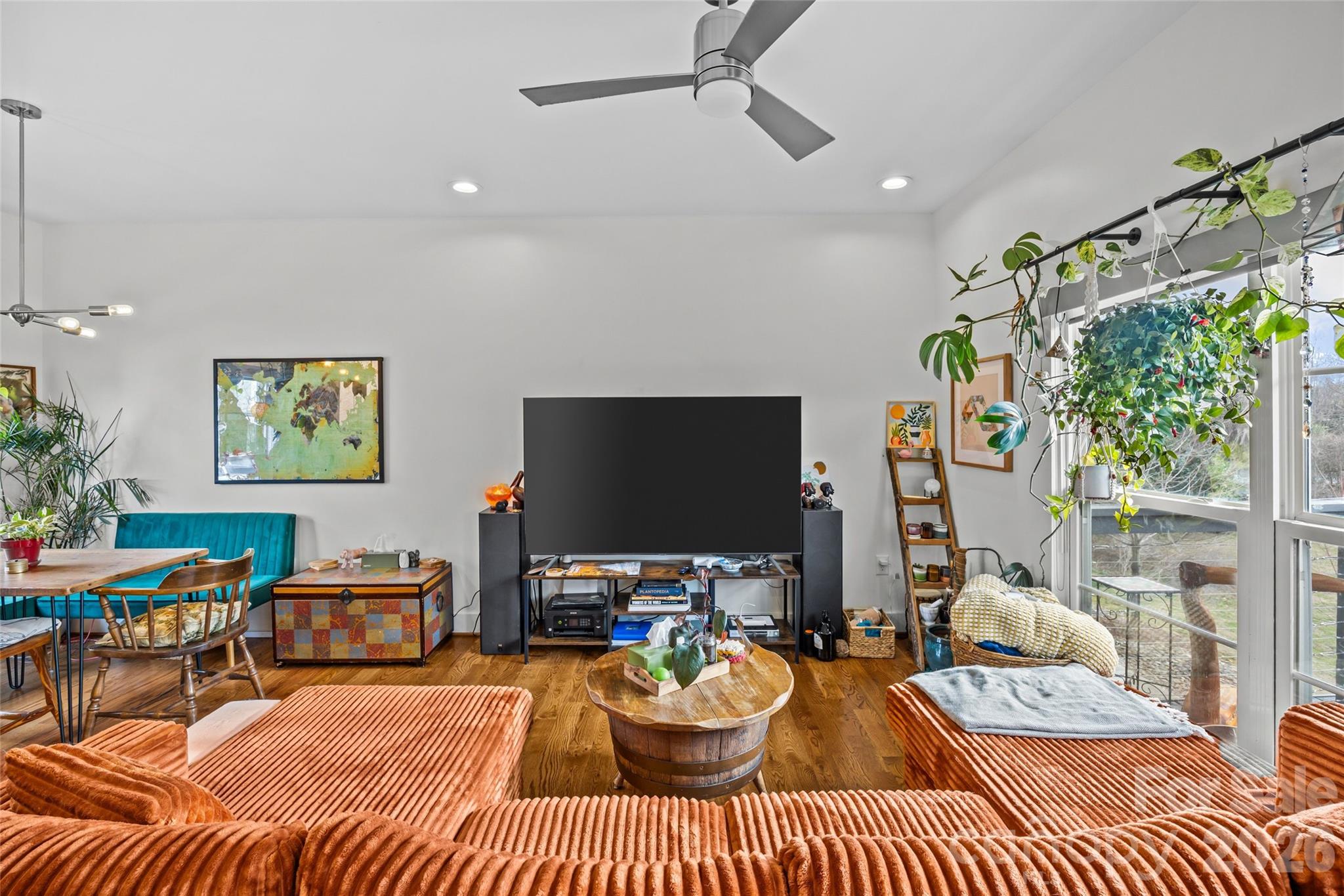 1108 North Alexander Street Charlotte, NC 28206 - Photo 12 of 37 a living room with furniture a flat screen tv and a large window