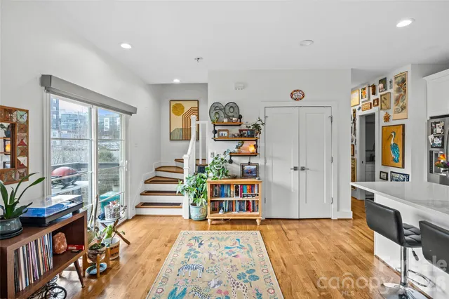 a living room with furniture and kitchen view