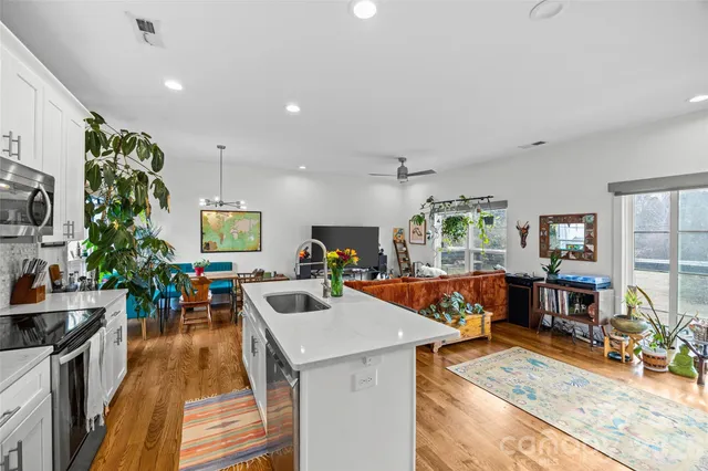 a kitchen with stainless steel appliances granite countertop a refrigerator and a stove top oven