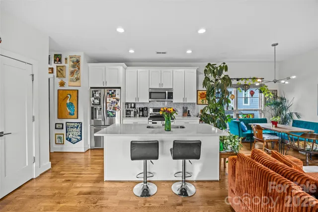a living room with furniture a flat screen tv and a large window